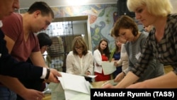 Members of a local election commission count ballots at a polling station following municipal elections in Ryzazan on September 10.