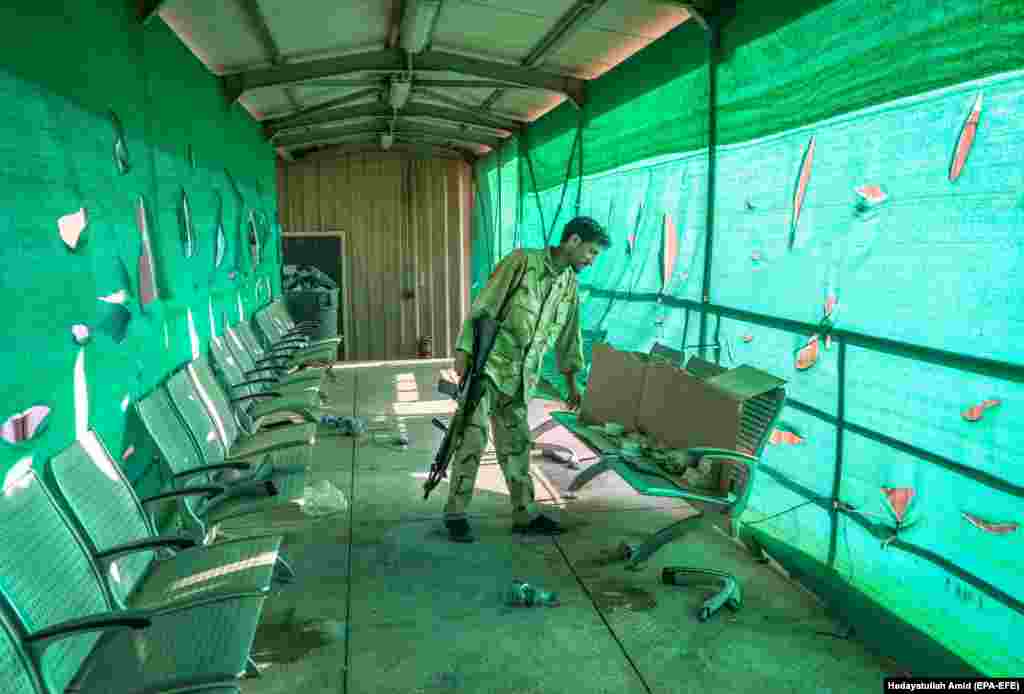 An Afghan soldier looks through items left by the U.S. military at Bagram Airfield on July 5. 