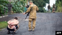 Ukrainian forces detain a pro-Russia separatist in the village of Chornukhine in the Lugansk region in August 2014.