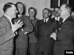 German Foreign Minister Joachim von Ribbentrop (right) talks with Adolf Hitler on his arrival in Berlin after signing the pact in Moscow.