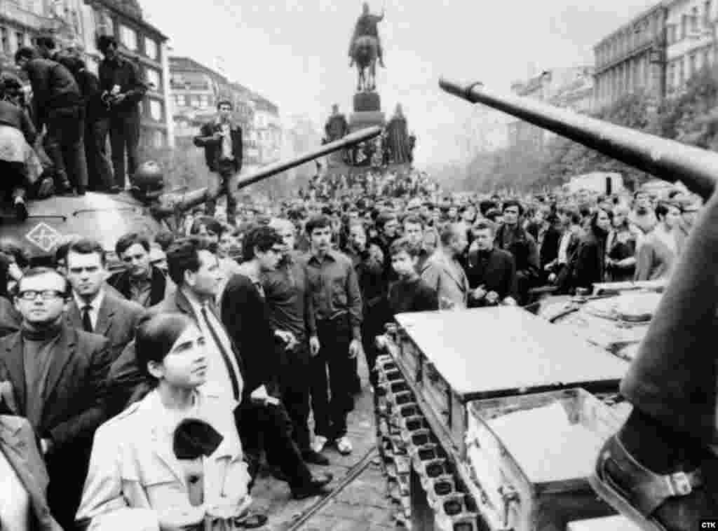 Soviet tanks are surrounded by crowds of Czechs protesting against the invasion on Prague's Wenceslas Square on August 21, 1968.