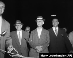 Rudolf Abel (center) is accompanied by U.S. marshals at Newark Airport on August 8, 1957.
