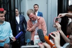 Russian journalist Ivan Golunov gestures to reporters after being released from police custody in June 2019.