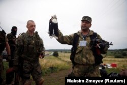 A pro-Russia separatist holds a stuffed toy found at the crash site of Malaysia Airlines flight MH17, near the settlement of Hrabove in the Donetsk region. (file photo)