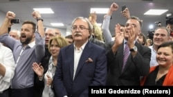 Grigol Vashadze (center) and his supporters react after the announcement of the first exit poll results in the presidential election on October 28.