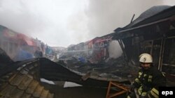 Firefighters work at a marketplace that was set on fire after a terrorist attack in Grozny on December 4.