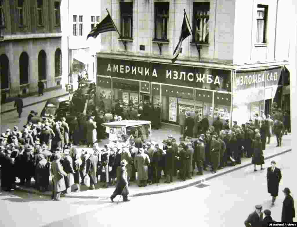 Locals in Belgrade line up outside a "U.S. Information Center" to read newspapers reporting the death of Stalin in 1953. 