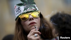 A woman smokes during a rally in support of the decriminalization of marijuana in Tbilisi in 2015.
