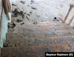 Broken glass litters a stairway in Gazyan.