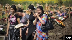 Friends and relatives of a flood victim mourn in a cemetery in Krymsk in the southern Krasnodar territory on July 9.