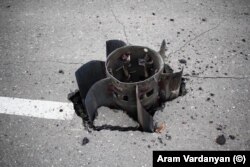 The tail fins of a large rocket that was embedded in a road in Stepanakert