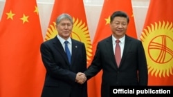 Kyrgyz President Almazbek Atambaev (left) meets with Chinese President Xi Jinping. Like other Central Asian leaders, he won't threaten key economic ties over ethnic brethren.