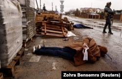 Bodies on a street in Bucha on April 3. "The general sentiment that [Putin's] been saying is that Ukraine doesn't have a right to exist. That Ukraine is a sort of international accident…. And therefore, he says, Ukraine doesn't have a right to exist," David Simon says. "At some level, that's different from saying Ukrainians don't have a right to exist."