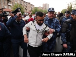 A young protester is led away by police on April 20.