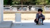 Bir ýaşuly adam duralganyň kölegesinde günden goranyp otyr (arhiw)