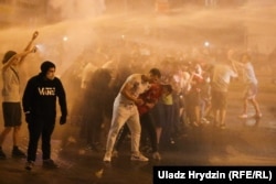 Protesters being blasted with water cannon in central Minsk on August 9.