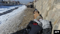 Drug addicts use heroin and other narcotics near the Kabul River in the capital.
