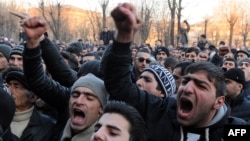 Armenian protesters shout slogans in front of the prosecutor's office in Gyumri.