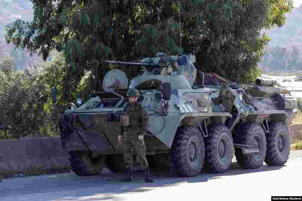 A Russian soldier guards a vehicle near the Hmeimim air base. In a written statement describing his escape from Syria, ousted leader Bashar Al-Assad says he was initially flown from Damascus to the Hmeimim base amid the massive rebel advance . From there he was eventually airlifted to Russia on December 8 after the Russian facility "came under intensified attack by drone strikes." 