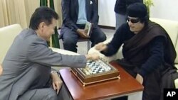 Staving off what many expected would be a quick checkmate has become something close to victory for Libya's Muammar Qaddafi (right).