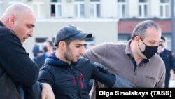 A man is detained during a protest rally in Vladikavkaz on April 20.