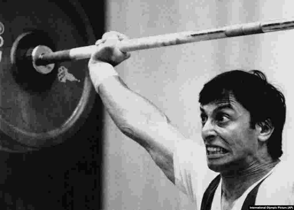 French weightlifter Nicolas Lasorsa grimaces through a 125-kilogram snatch. 