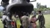 U.S. and Pakistani service members help flood victims exit a U.S. Army helicopter in Khwazakhela 
