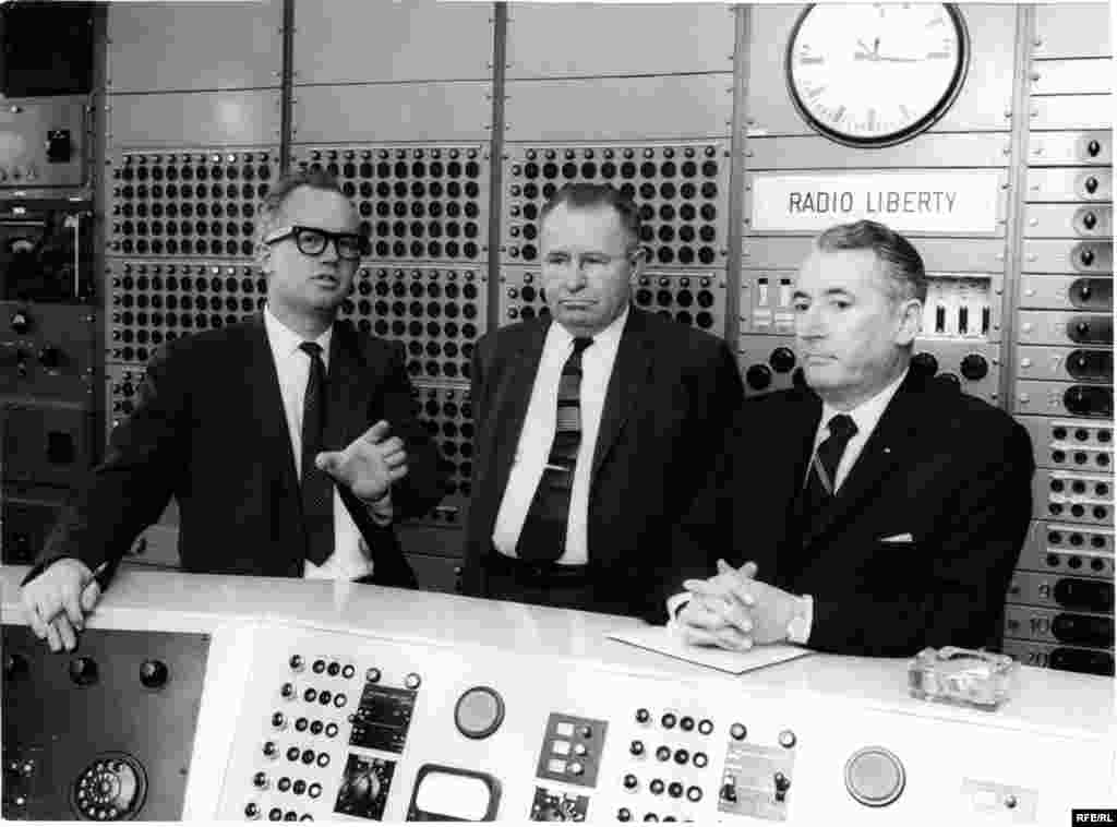 The head of Radio Liberty's Engineering Department, Richard Jewel Tanksley (left), shows some guests the master control room in Munich in 1964.