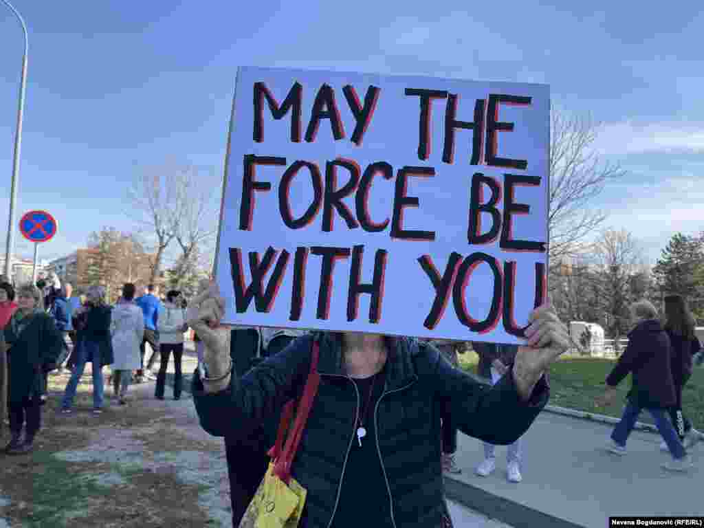 A protester carries a whistle and placard in Belgrade ahead of the march. Demonstrators say they will march to Novi Sad and join protesters there to blockade three critical bridges in the northern city. 