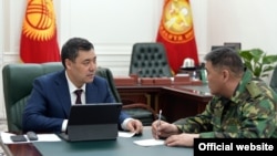 Kyrgyz President Sadyr Japarov (left) with Kamchybek Tashiev, the head of the State Committee for National Security, which has been ordered to check the authenticity of the diplomas of all public-sector workers and lawmakers. (file photo)