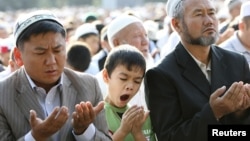 A boy yawns during Islamic prayers at a square in the Kyrgyz capital, Bishkek.