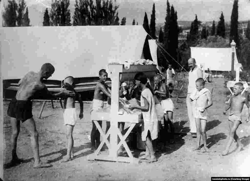 A rare image of the first camp on Artek in 1925, established on Soviet Russia's Crimean peninsula.The first camp featured four large tents, where children suffering from tuberculosis were housed and encouraged to maximise their time under the sun in the dry climate of Crimea.