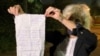 Lawyer Lyudmila Kazak holds up a complaint that one of her clients wrote and handed over to her in Minsk on September 25. Kazak herself was abducted and later found guilty of "failing to obey" police at an opposition rally that she says she didn't even attend.
