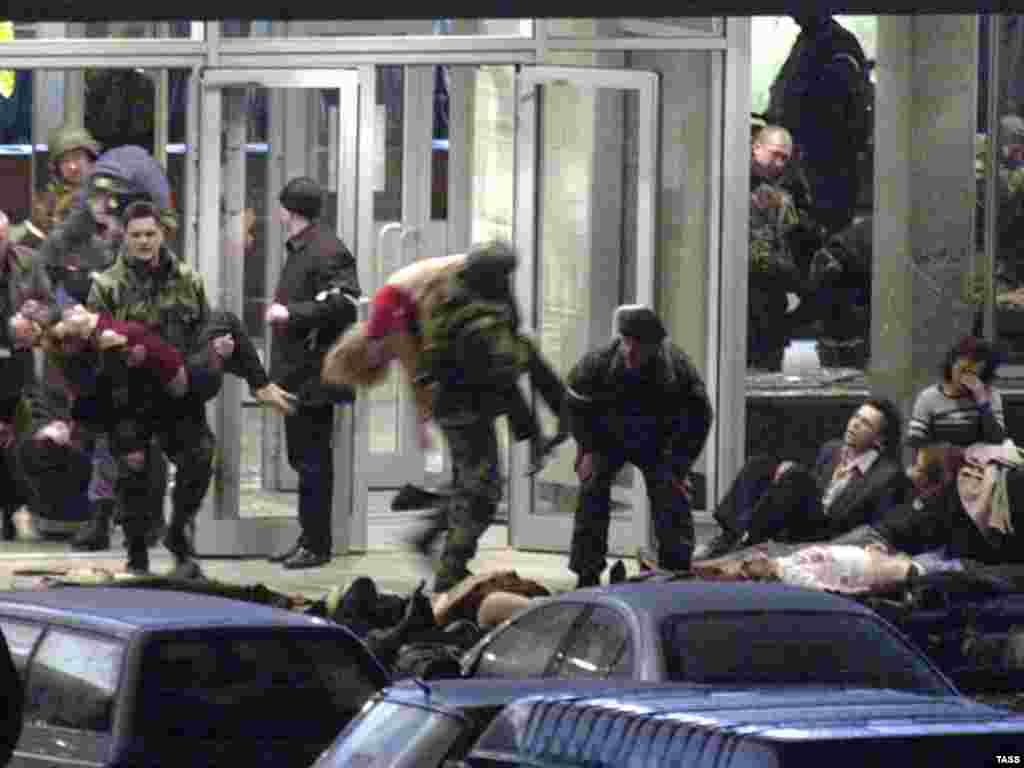 Troops carry out hostages, many of whom were badly affected by the gas pumped into the theater to subdue the militants.