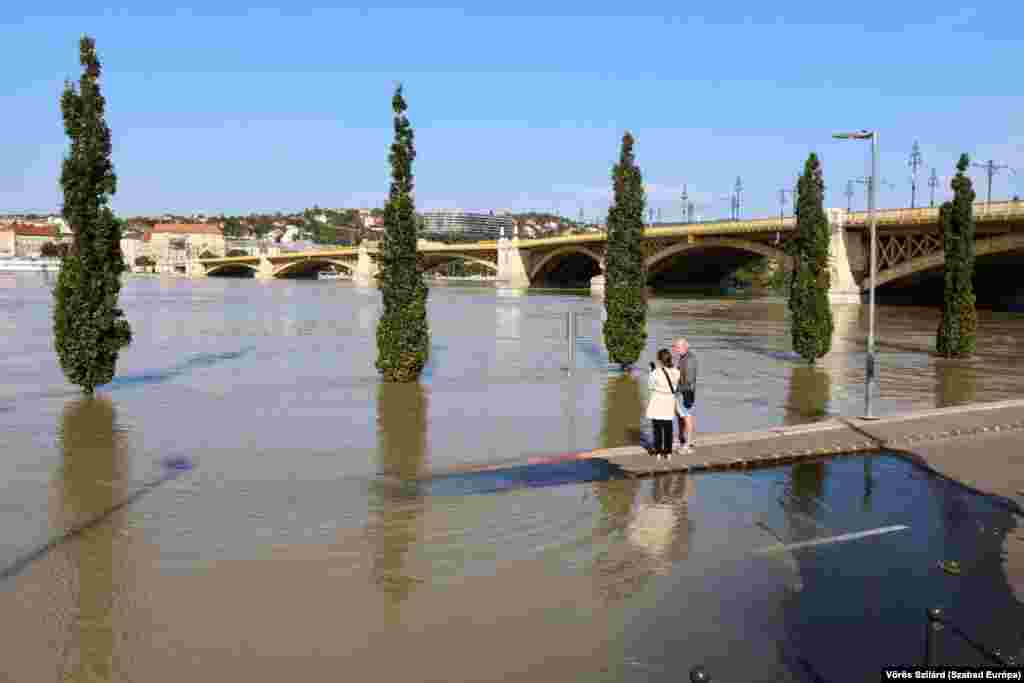 People observe the overflowing Danube near Budapest's Margaret Bridge.