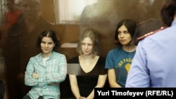 Members of the female punk collective Pussy Riot sit in a glass-walled cage after a court hearing in Moscow last month. 