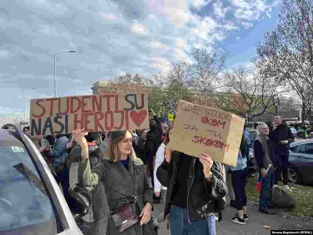 Protesters hold signs declaring "Students are our heroes" and "Where students look, I jump," ahead of the march. 
