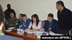 Nagorno Karabakh - Shahbaz Quliyev (R) and Dilham Askerov (third from L), Azerbaijani citizens charged by Karabakh's authorities with sabotage and murder, stand before a court in Stepanakert,27Oct,2014
