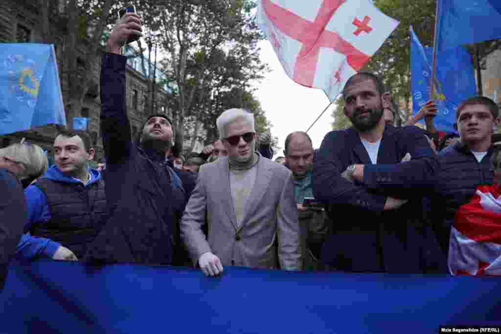 The son of Bidzina Ivanishvili, Tsotne Ivanishvili (center), and sportsman and deputy candidate Geno Petriashvili (second right) join the procession of supporters of the Georgian Dream before the start of the pre-election rally. 