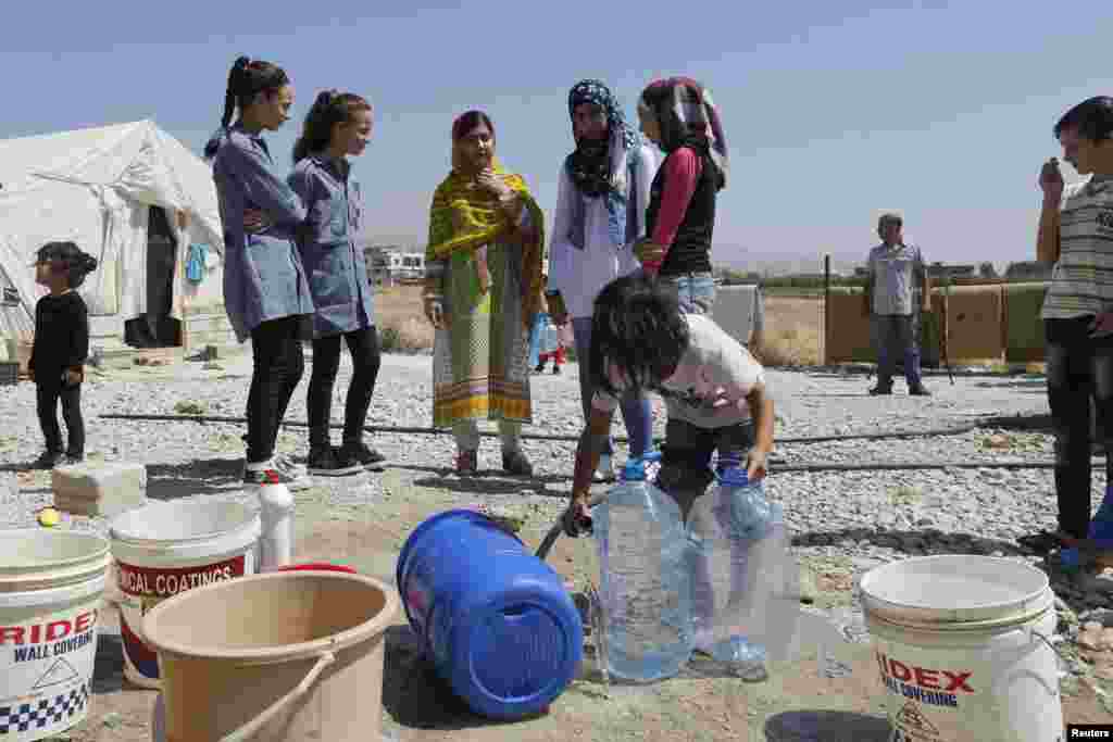 Yousafzai talks with schoolgirls at the Abrar Syrian refugee informal settlement in Lebanon's Bekaa Valley on July 12, 2015.