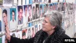 A photo of Nesrete Kumnova's son, Albion, is among the more than 300 such photos of the "not found" hanging on a fence outside the Kosovar parliament.