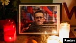 People light candles at a vigil following the death of Russian opposition leader Aleksei Navalny, near the Eiffel Tower in Paris on February 19.