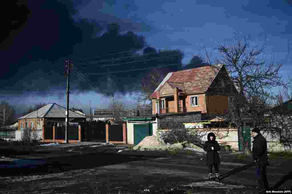 Black smoke rises from a military airport in Chuhuiv near Kharkiv.