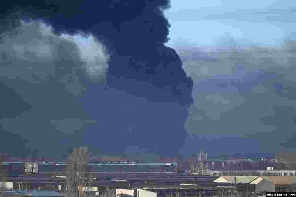 Black smoke rises from a military airport in Chuhuiv near Kharkiv.