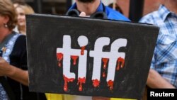 Protesters gather outside the Toronto International Film Festival (TIFF) to protest Russians At War, a documentary about Russian troops fighting in Ukraine, in Toronto on September 10.