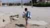 A boy carries groceries in Balkanabat. Amid Turkmenistan's economic crisis and deepening poverty, there has been an increase in anecdotal reports of burglary, mugging, and supermarket theft across the country.
