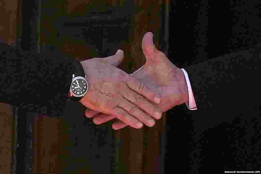 A close-up of a handshake between President Vladimir Putin (left) and President Joe Biden as they meet on June 16. 