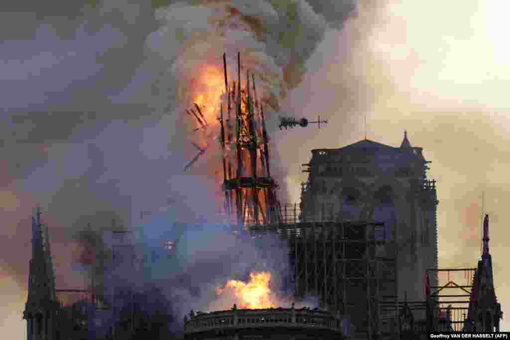 The spire collapses in flames during the blaze on April 15, 2019.