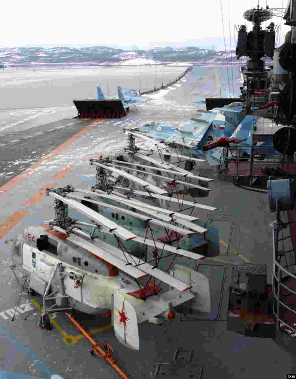 Helicopters and fighter jets on the flight deck of the Admiral Kuznetsov. The carrier is capable of deploying with 52 aircraft aboard. The vessel's air wing, however, is limited by its lack of an aircraft catapult. Most modern aircraft carriers are fitted with a steam-powered catapult that flings aircraft along the deck runway.