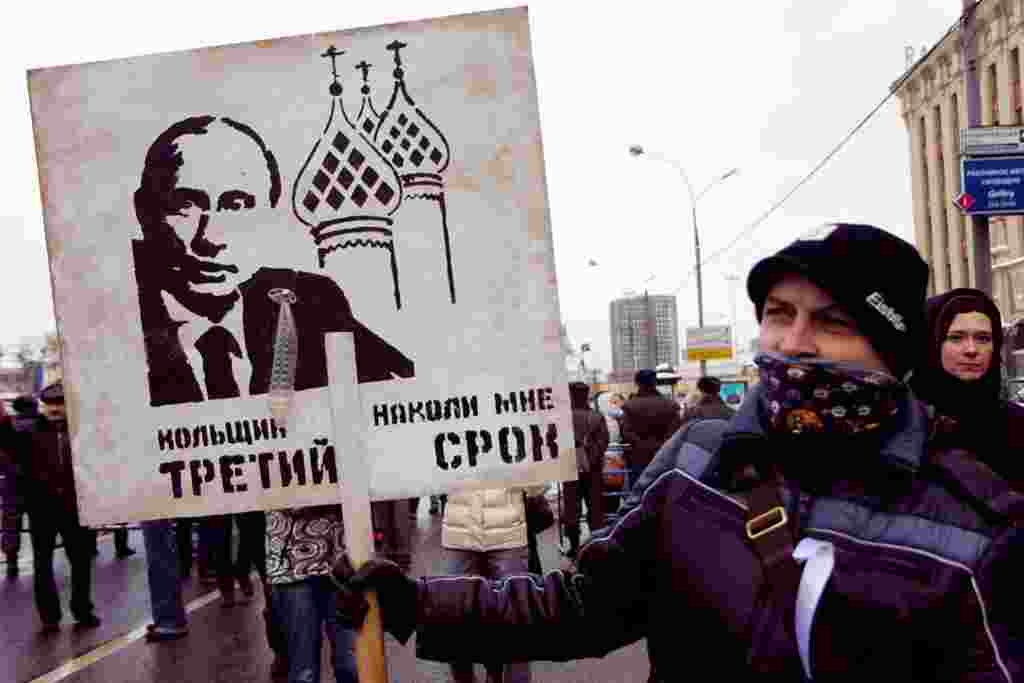 A reference to Russian prison tattoos, where criminals who receive a third term would receive a tattoo of Orthodox church domes. Putin is seeking a third term as president.